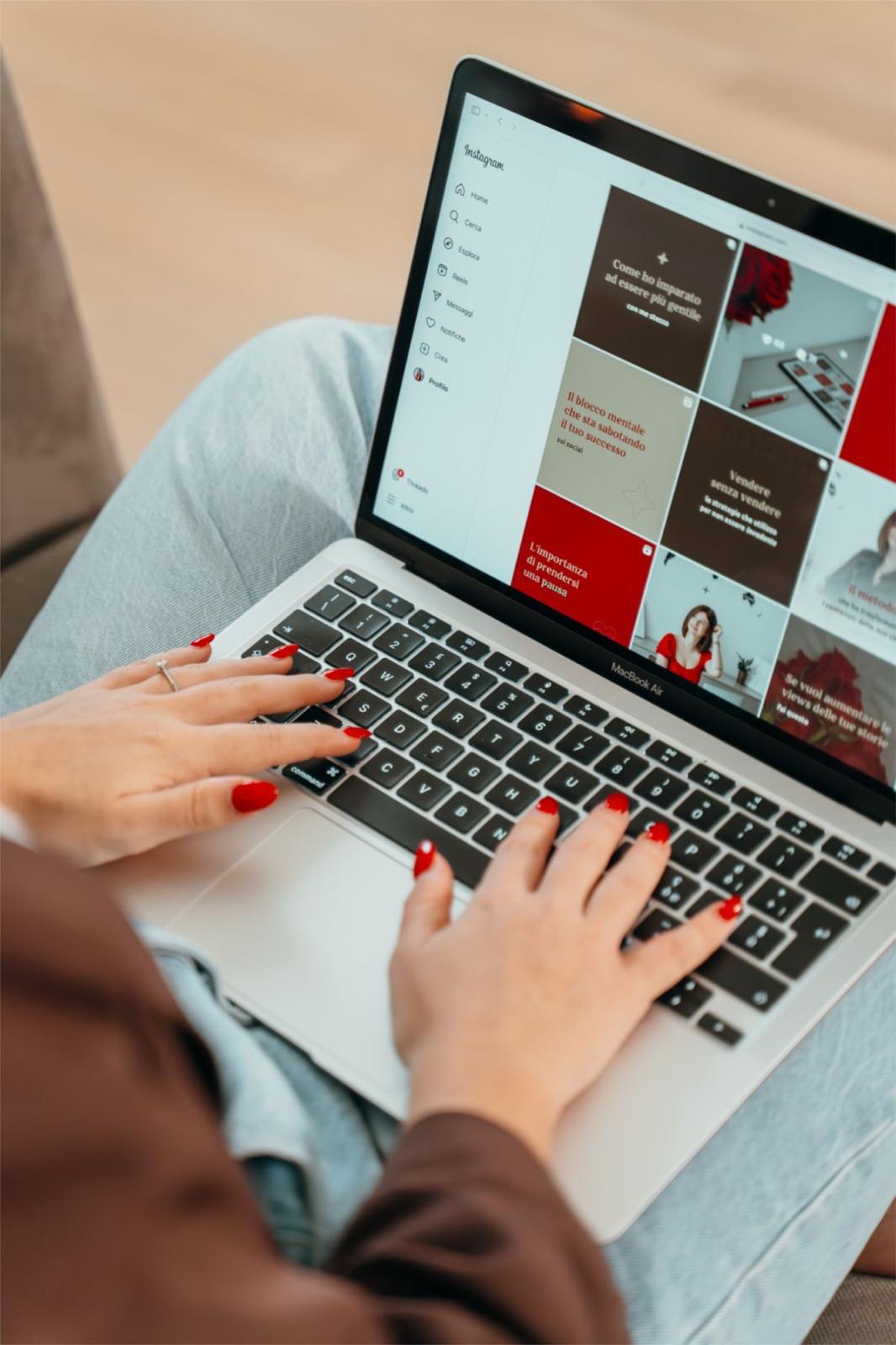 Typing on a laptop showing a social media profile